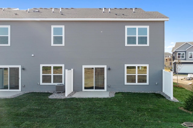 back of house featuring cooling unit, a patio, and a yard