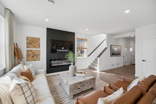 living room with light hardwood / wood-style floors and a fireplace