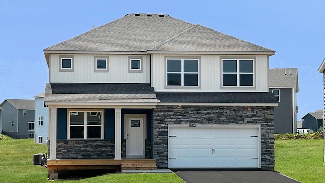 13621 Aulden Ave, Rosemount, MN 55068 - view of front of property with stone siding, a front lawn, driveway, and an attached garage