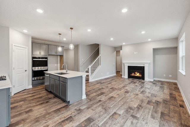 13621 Aulden Ave, Rosemount, MN 55068 - kitchen featuring gray cabinets, a sink, appliances with stainless steel finishes, recessed lighting, and dark wood-type flooring