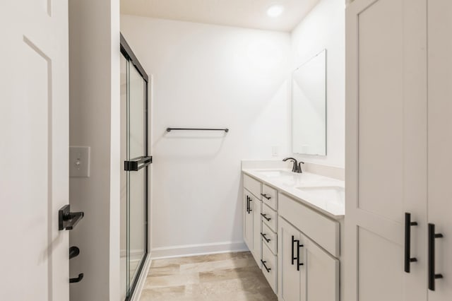 bathroom with an enclosed shower and vanity