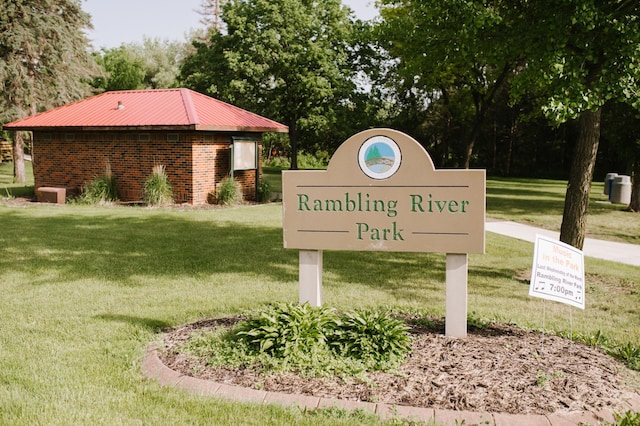 community sign featuring a lawn