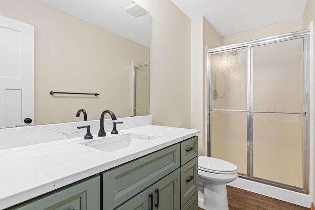 bathroom with toilet, an enclosed shower, wood-type flooring, a textured ceiling, and vanity