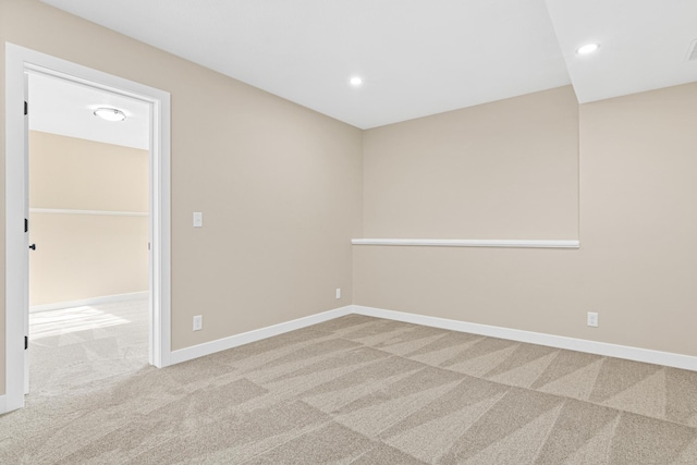 carpeted empty room featuring baseboards and recessed lighting