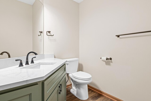 6462 Kingfisher Ct, Lino Lakes, MN 55014 - half bath with wood finished floors, toilet, vanity, and baseboards