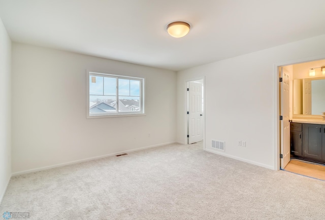 carpeted spare room with sink