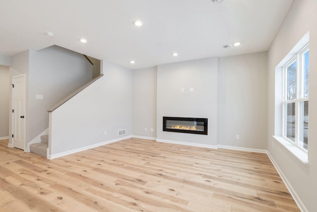 unfurnished living room featuring light hardwood / wood-style floors