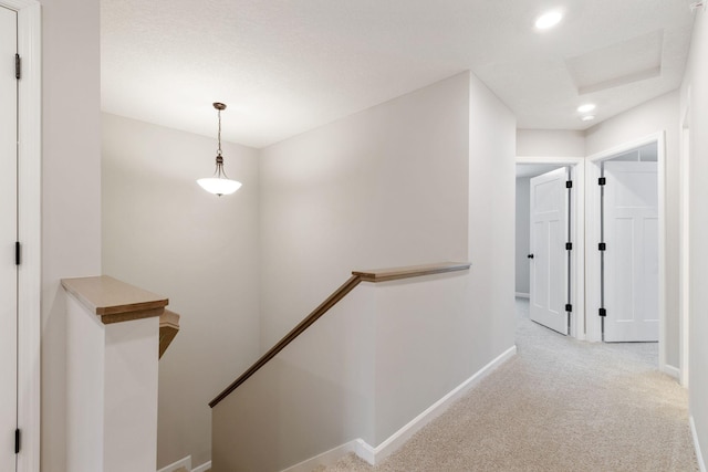 corridor with light colored carpet