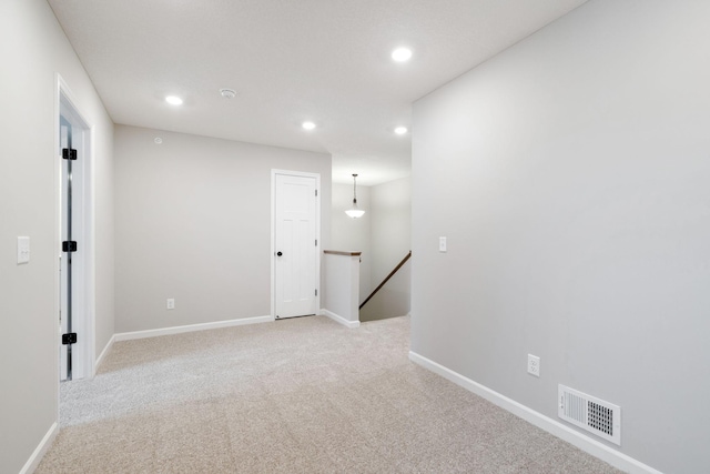 unfurnished room with light colored carpet