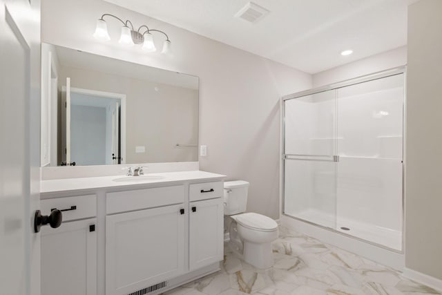 bathroom with vanity, an enclosed shower, and toilet