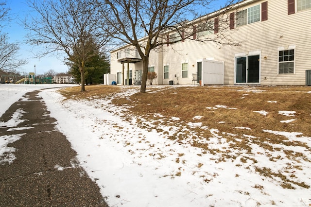 view of snow covered rear of property