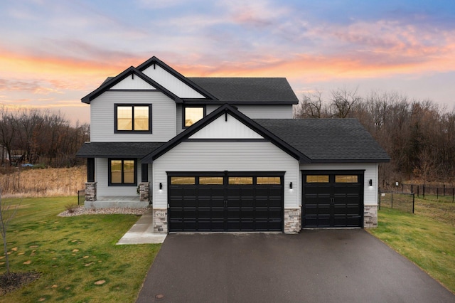 view of front of house with a yard and a garage