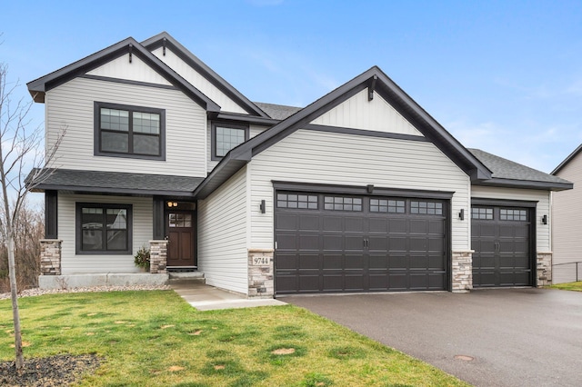 view of front of house featuring a front yard and a garage