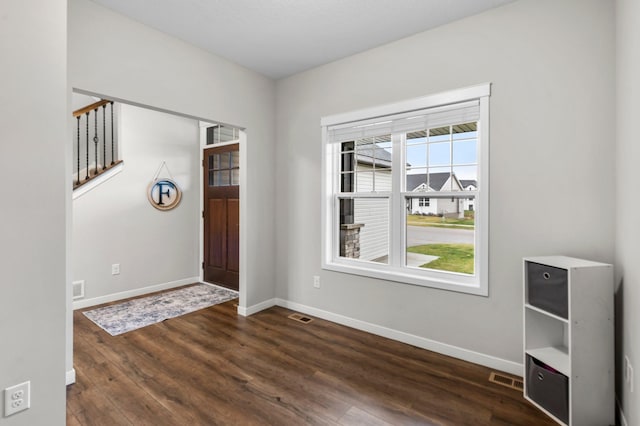 entrance foyer with dark hardwood / wood-style flooring