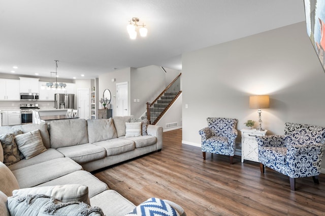 living room featuring a chandelier and hardwood / wood-style flooring