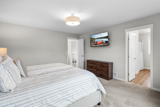 bedroom featuring light colored carpet