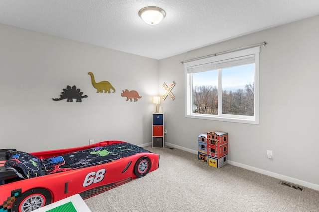 carpeted bedroom featuring a textured ceiling