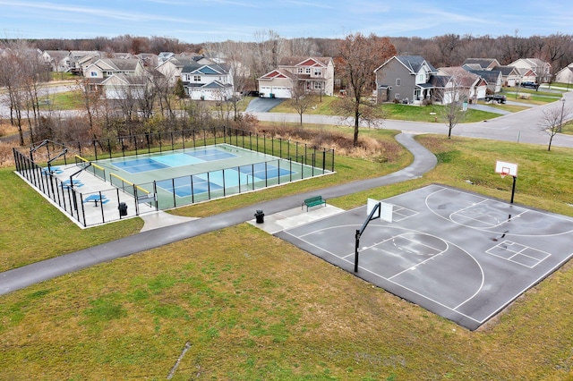 view of basketball court with tennis court and a yard