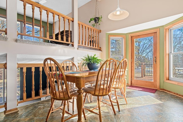 dining area featuring a towering ceiling