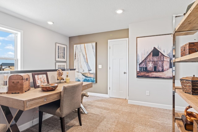 office with a textured ceiling and light colored carpet