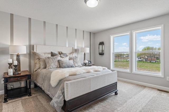 bedroom featuring carpet flooring and multiple windows