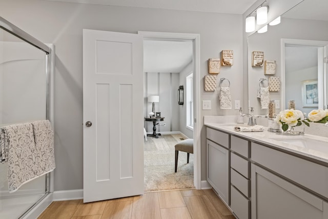 bathroom with an enclosed shower and vanity