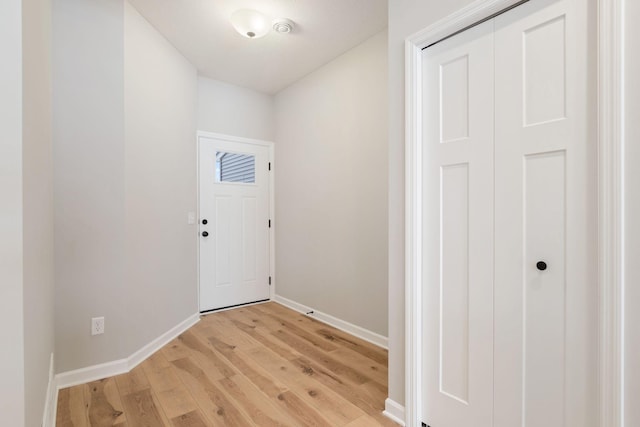 foyer entrance with light wood finished floors and baseboards