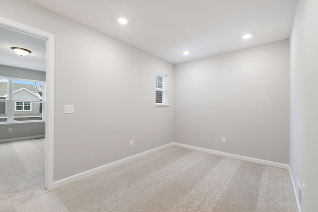 spare room with carpet flooring, recessed lighting, and baseboards