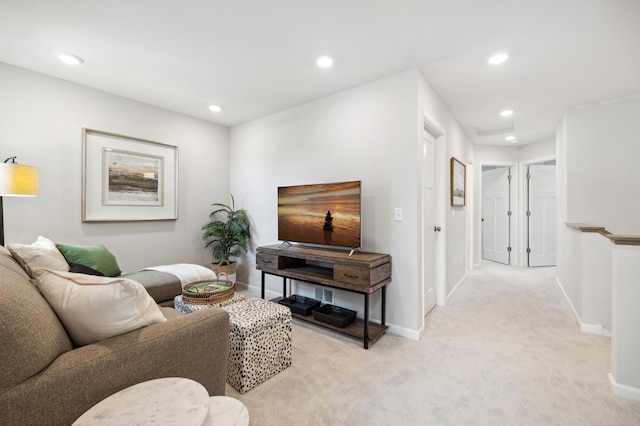 living room with recessed lighting, light colored carpet, and baseboards