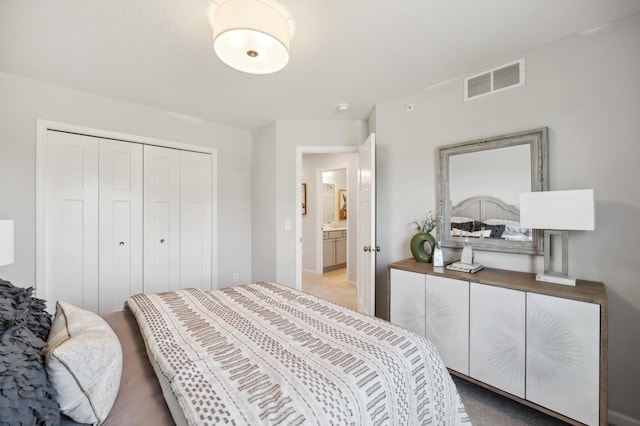 bedroom with light carpet, visible vents, and a closet