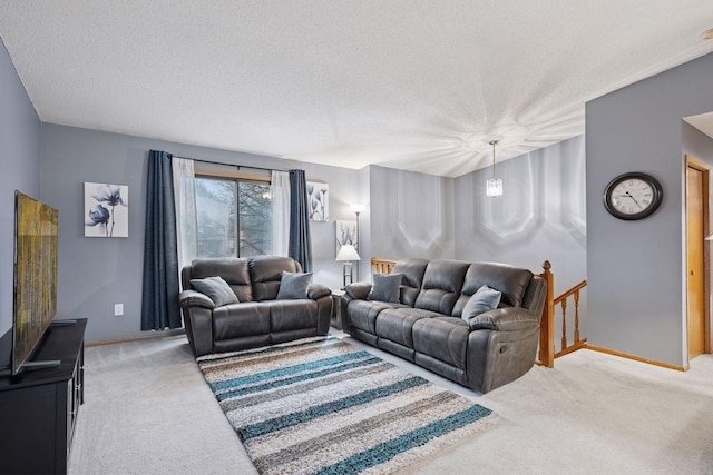 carpeted living room featuring a textured ceiling and baseboards