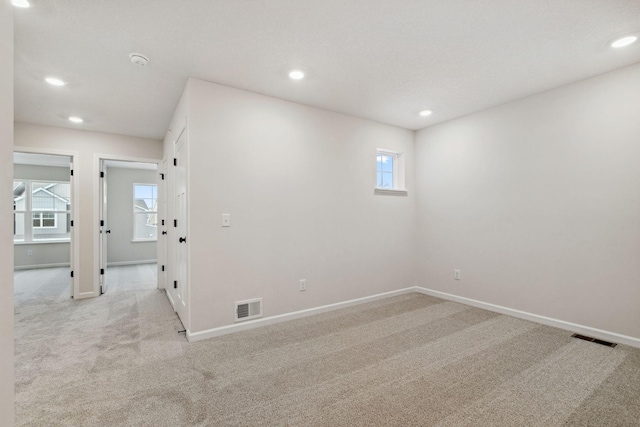 spare room with light colored carpet