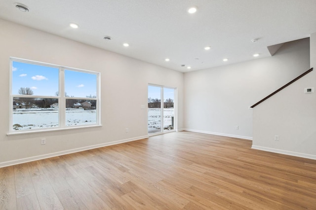 unfurnished living room featuring light hardwood / wood-style flooring