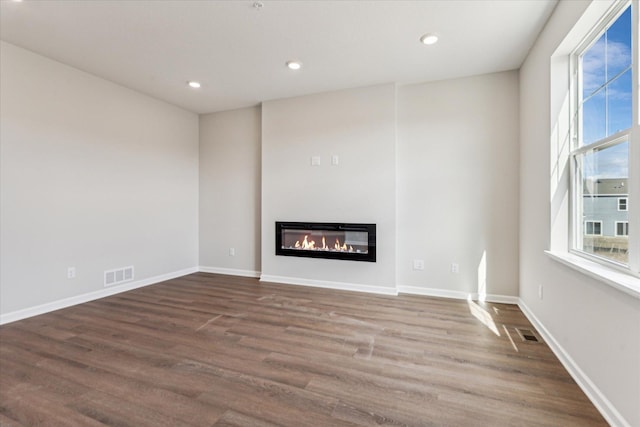 unfurnished living room featuring dark hardwood / wood-style flooring