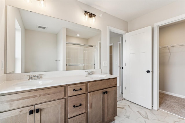 bathroom featuring an enclosed shower and vanity