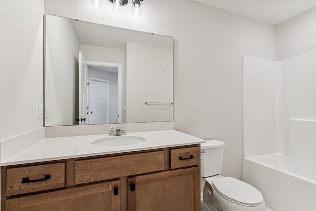 full bathroom featuring washtub / shower combination, vanity, and toilet