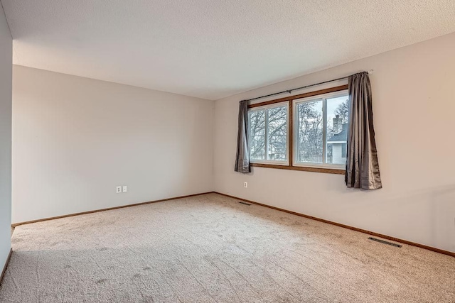 unfurnished room featuring carpet floors and a textured ceiling