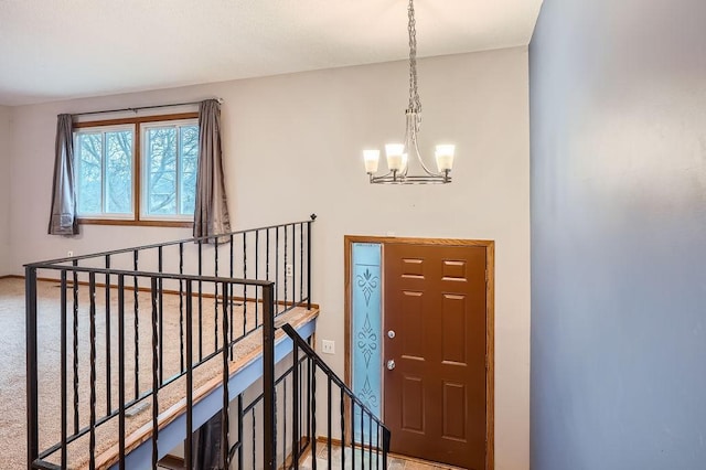 foyer entrance featuring an inviting chandelier