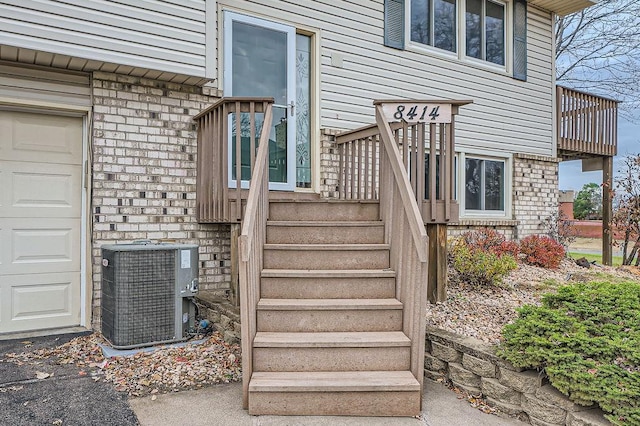 property entrance featuring central AC unit