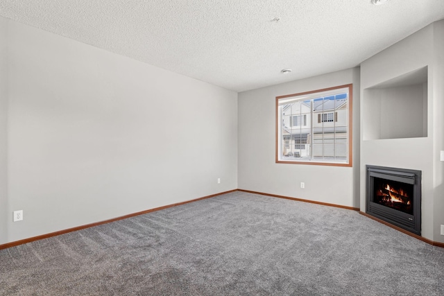 unfurnished living room featuring carpet and a textured ceiling