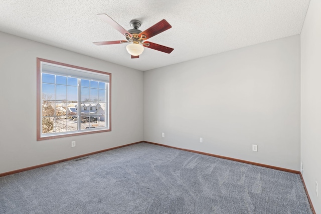 unfurnished room featuring ceiling fan, carpet flooring, and a textured ceiling