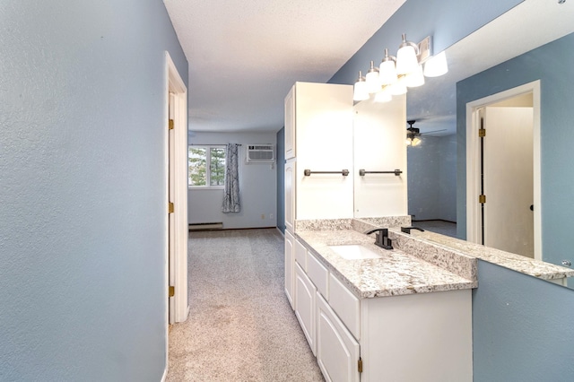 bathroom with vanity, ceiling fan, a baseboard radiator, and a wall mounted AC