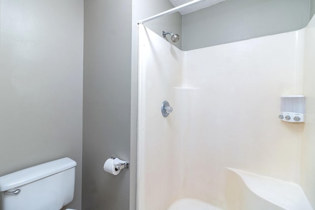 bathroom featuring toilet and walk in shower