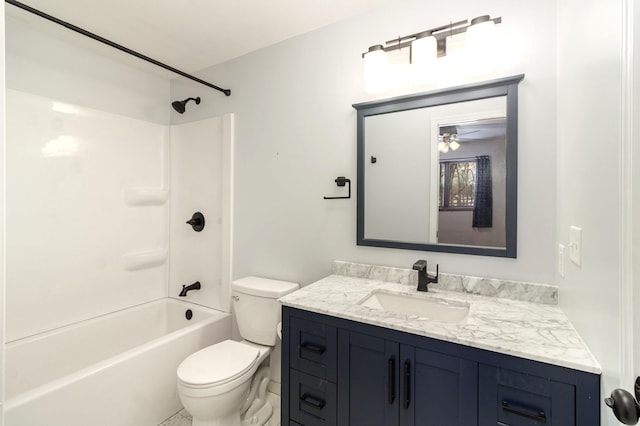 full bathroom featuring washtub / shower combination, vanity, and toilet