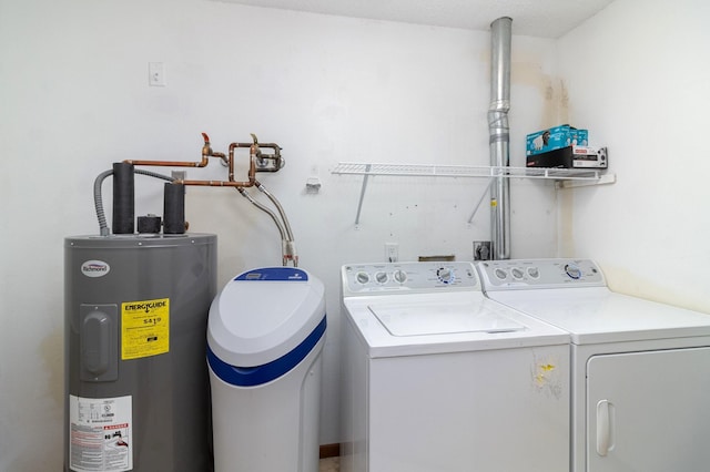 clothes washing area featuring washer and clothes dryer and water heater