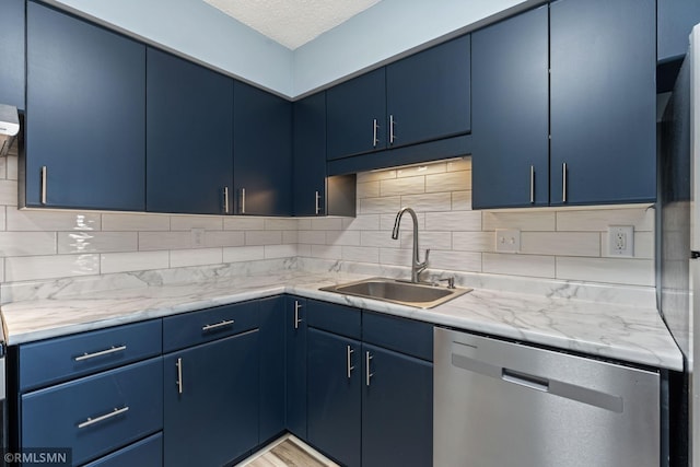 kitchen with stainless steel dishwasher, blue cabinets, and sink