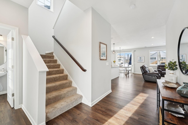 stairs featuring hardwood / wood-style floors