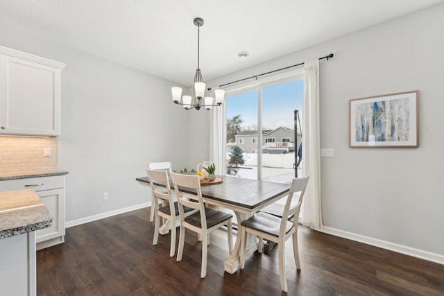 dining area with a chandelier and dark hardwood / wood-style flooring