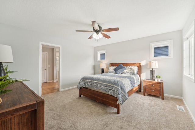 bedroom with light colored carpet and ceiling fan