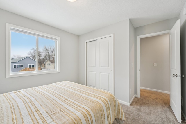 bedroom featuring a closet and light carpet